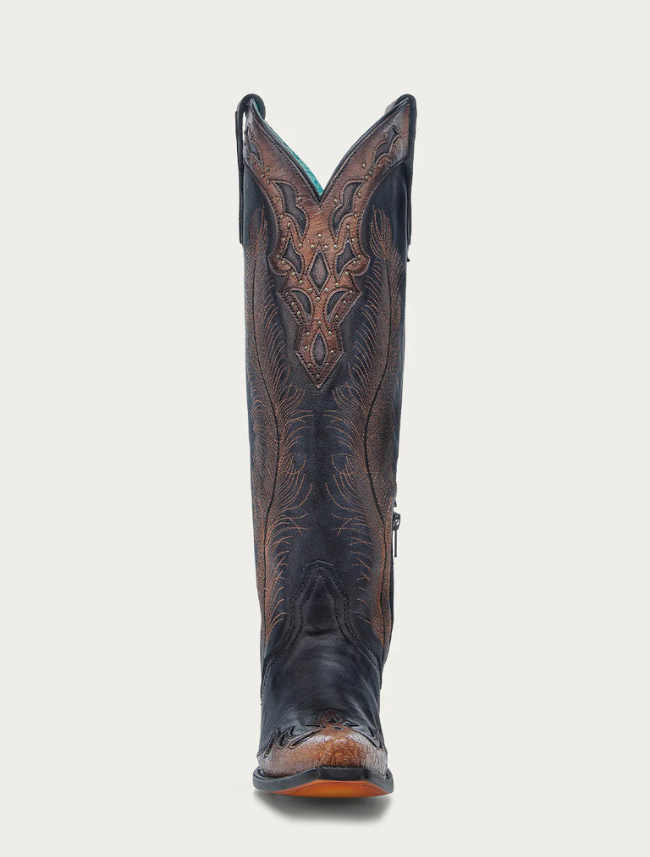 Black cowboy boot with intricate brown leather design on a light gray background