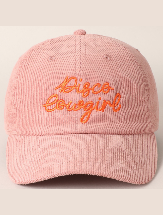 Front view of a corduroy trucker cap with glittery "Disco Cowgirl" text and mesh back.