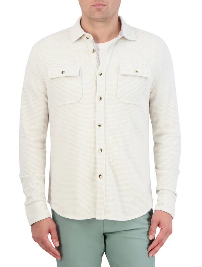 Man wearing an off-white button-up shirt with a white background