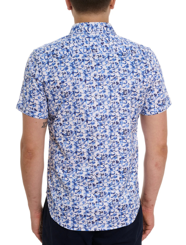 Man wearing a blue and white floral patterned shirt on a white background