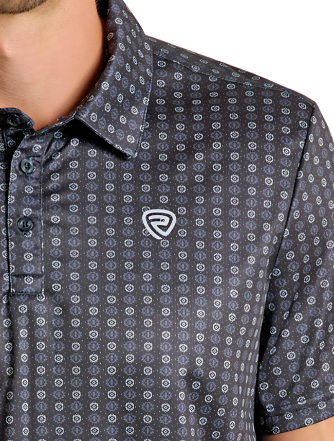 Close-up of shoulder of man wearing a grey polo with geometric print on a white background.