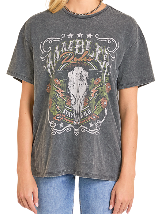 Woman wearing a graphic t-shirt with a cow skull design and text on a white background
