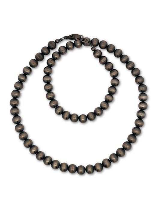 Top down view of sterling silver beaded necklace