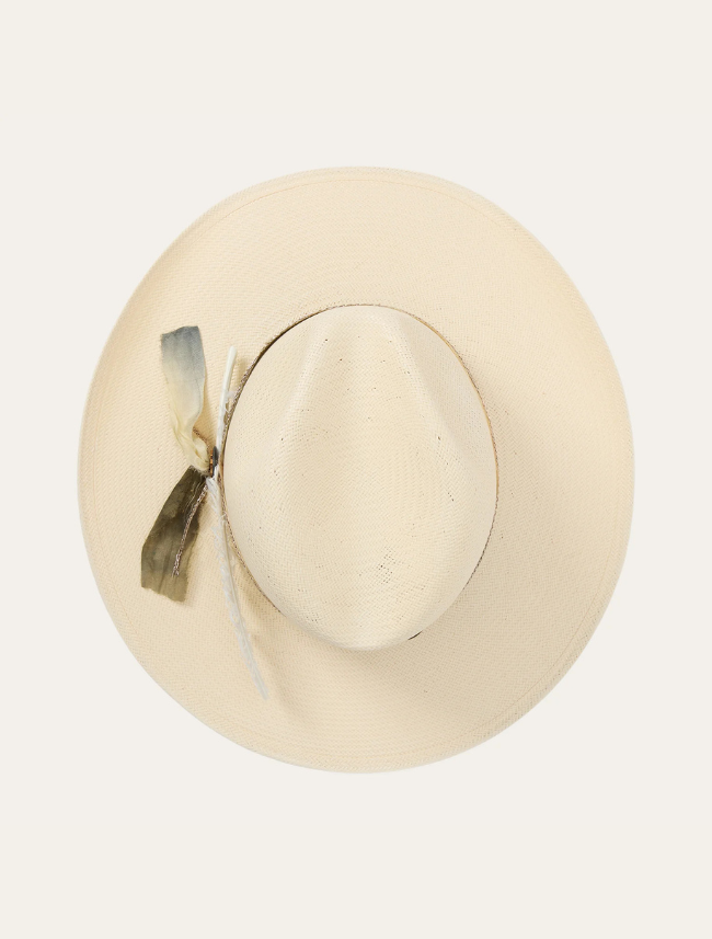 Beige straw hat with a decorative bow on a light beige background