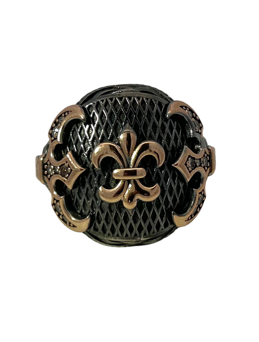 Front view of Storks Sterling Silver & Yellow Gold Ring with focus on gold fleur de lis in center