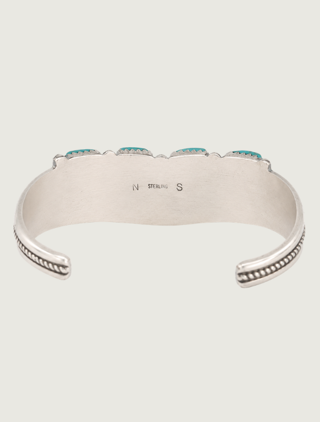 Interior view of sterling silver Sleeping Beauty turquoise needlepoint cuff bracelet with hallmark "NS" and "STERLING" present