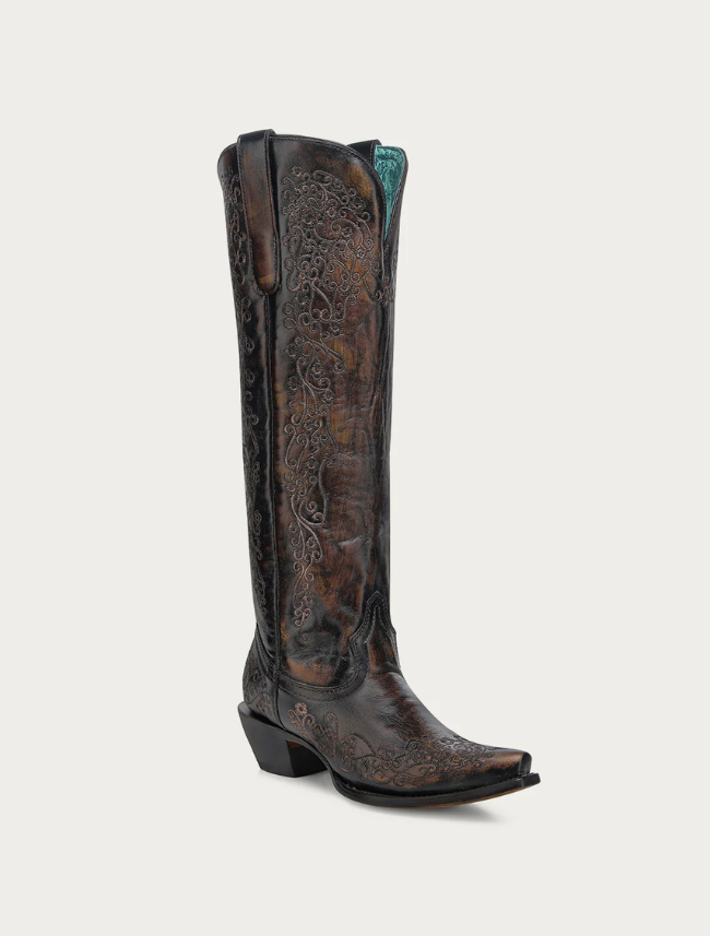 Brown cowboy boot with intricate designs on a white background