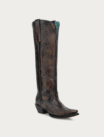 Brown cowboy boot with intricate designs on a white background