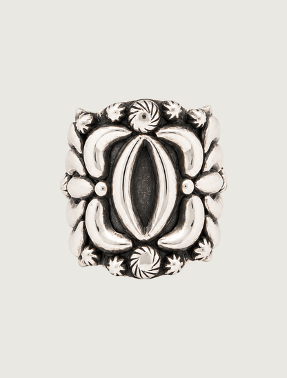 Darryl Becenti sterling silver statement ring, front view of oval center with floral repoussé detail