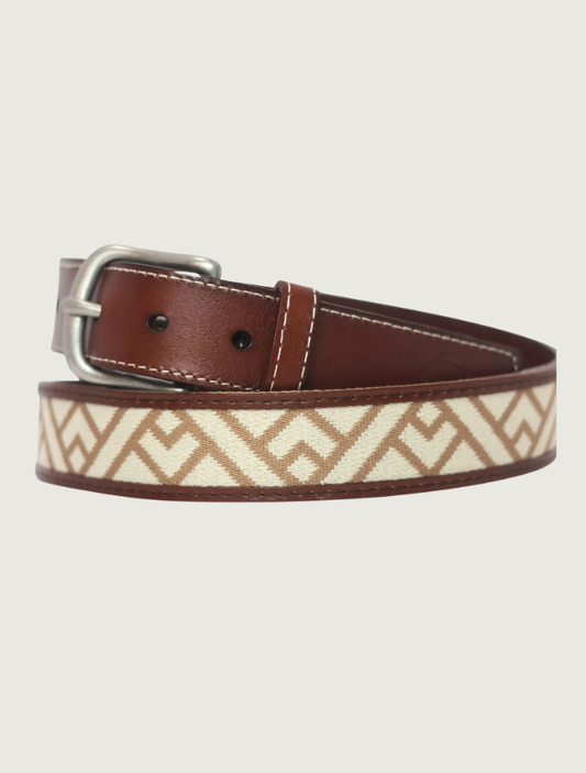 Cowboy Country Club Trailhead belt coiled to show its woven cream-and-tan geometric pattern, brown leather, and silver buckle