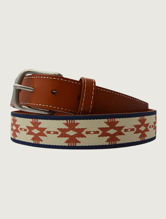Cowboy Country Club Bandera belt coiled to show its woven navy, cream, and rust pattern and tan leather buckle end