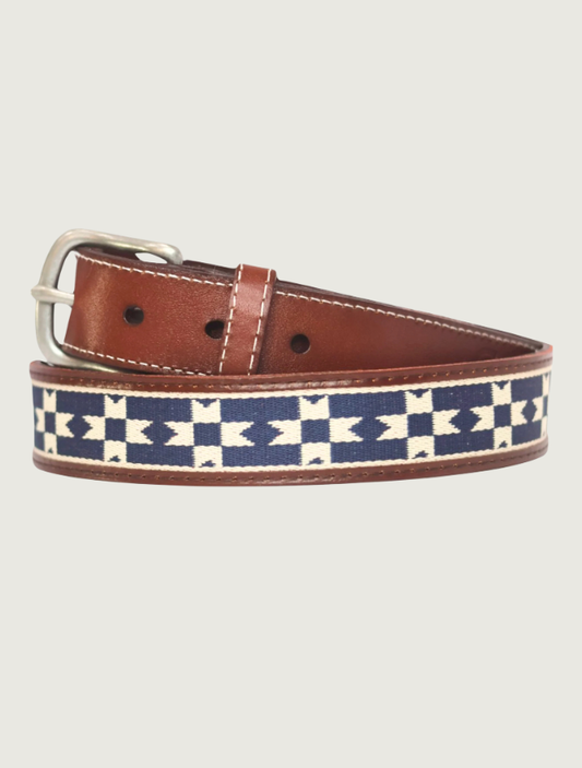 Cowboy Country Club Del Sol belt coiled to show its woven navy-and-cream geometric pattern, tan leather, and silver buckle