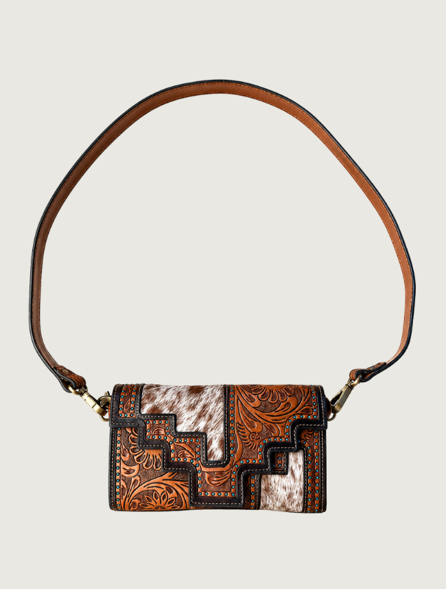 Tooled leather and cowhide crossbody bag with turquoise accents, strap extended