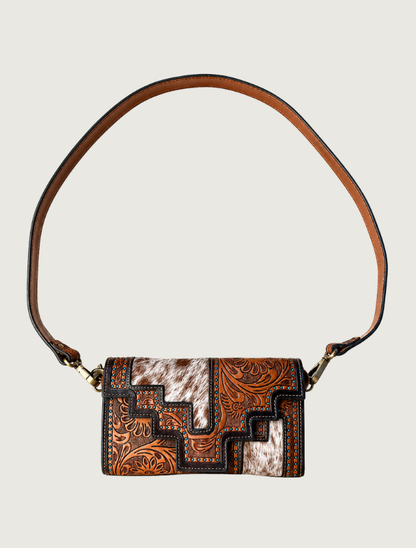 Tooled leather and cowhide crossbody bag with turquoise accents, strap extended