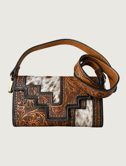 Tooled leather and cowhide crossbody bag with turquoise accents, strap coiled