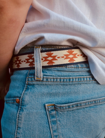 Bandera belt worn through the belt loops of light-wash jeans with an untucked white tee