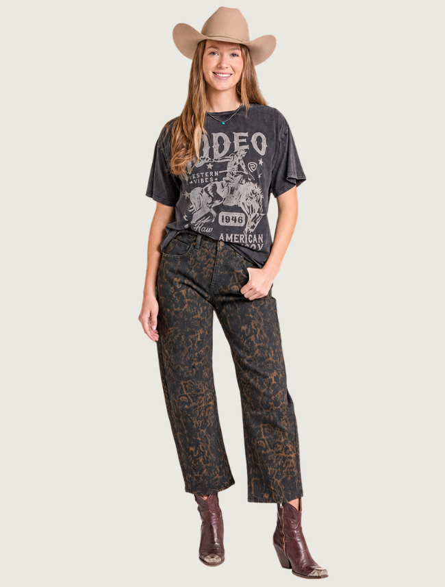 Woman wearing distressed oversized RODEO graphic t-shirt, front view, full body