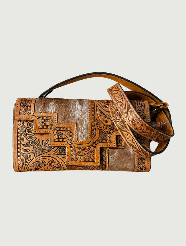 Tan tooled leather and cowhide crossbody bag, strap coiled