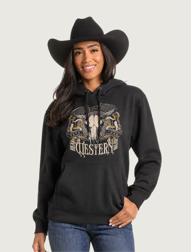Woman in a black cowboy hat wearing the black steer-skull Western graphic hoodie, front view