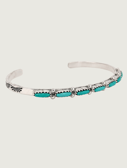 Quarter view of M.F.R. sterling silver Sleeping Beauty turquoise cuff with stamped fan detail