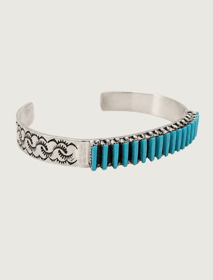 Side view of R.L. Lastyano sterling silver Sleeping Beauty turquoise needlepoint cuff with stamped scroll detail