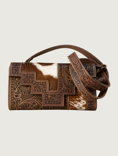 Brown tooled leather and cowhide crossbody bag, strap coiled