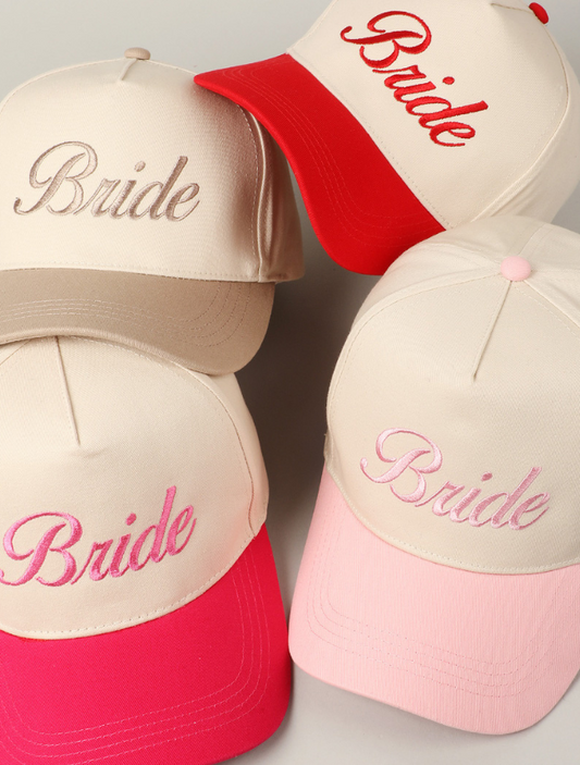 Group of trucker hats with “BRIDE” embroidered in bold, uppercase lettering on the structured front panel with different colors for summer hats