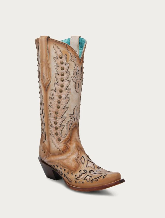 Tan cowboy boot with intricate designs on a white background