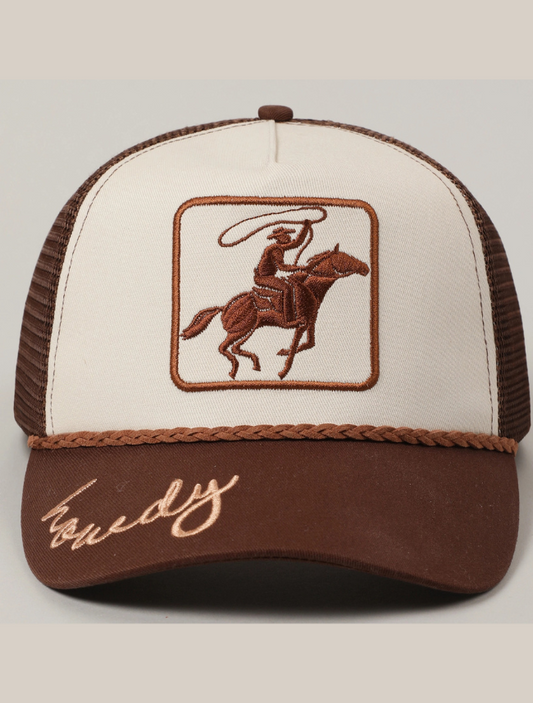 Brown and beige snapback hat with a mesh back, featuring a cowboy on horseback embroidery and “Howdy” stitched on the brim.