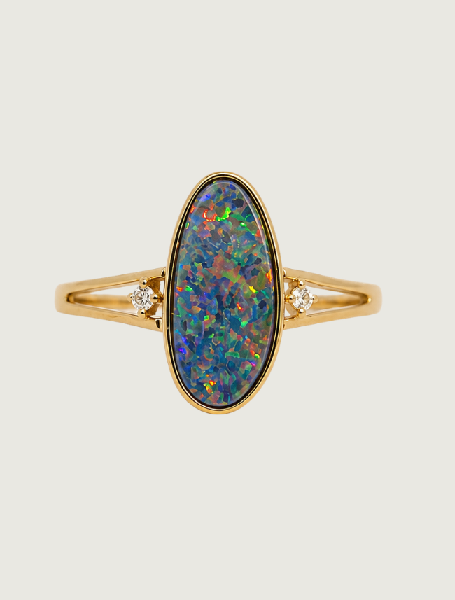 14K yellow gold split shank ring with bezel-set oval opal and diamond accents, front view