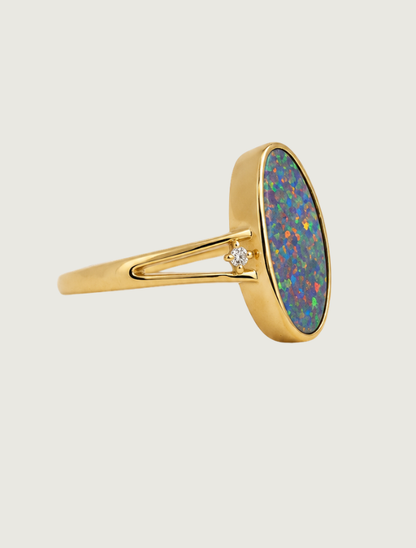 14K yellow gold split shank ring with bezel-set oval opal and diamond accents, side view