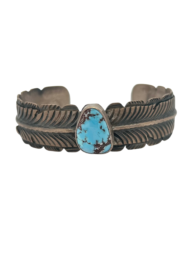 Front view of K.M. sterling silver turquoise cuff bracelet with feather detail