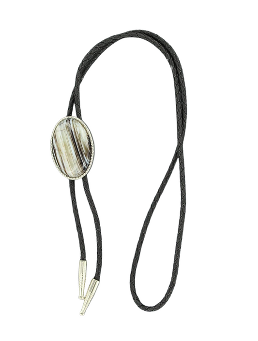 Bolo tie with a large sardyonyx stone on a white background