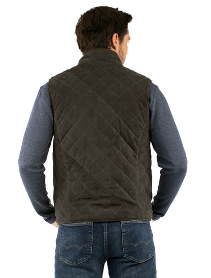 Man wearing a quilted brown vest over a blue shirt on a white background