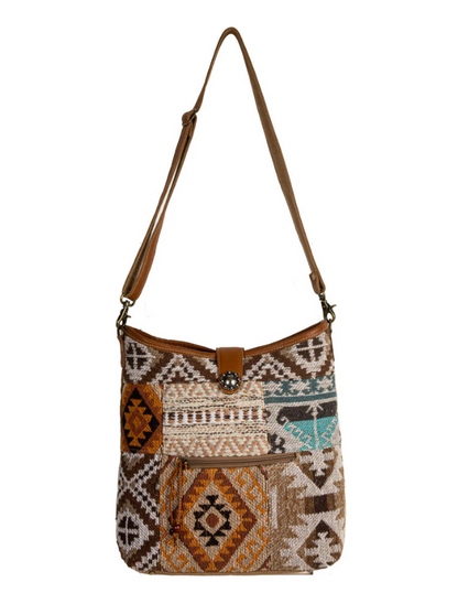 Patterned handbag with a brown strap on a white background