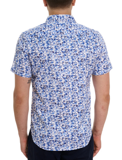 Man wearing a blue and white floral patterned shirt on a white background