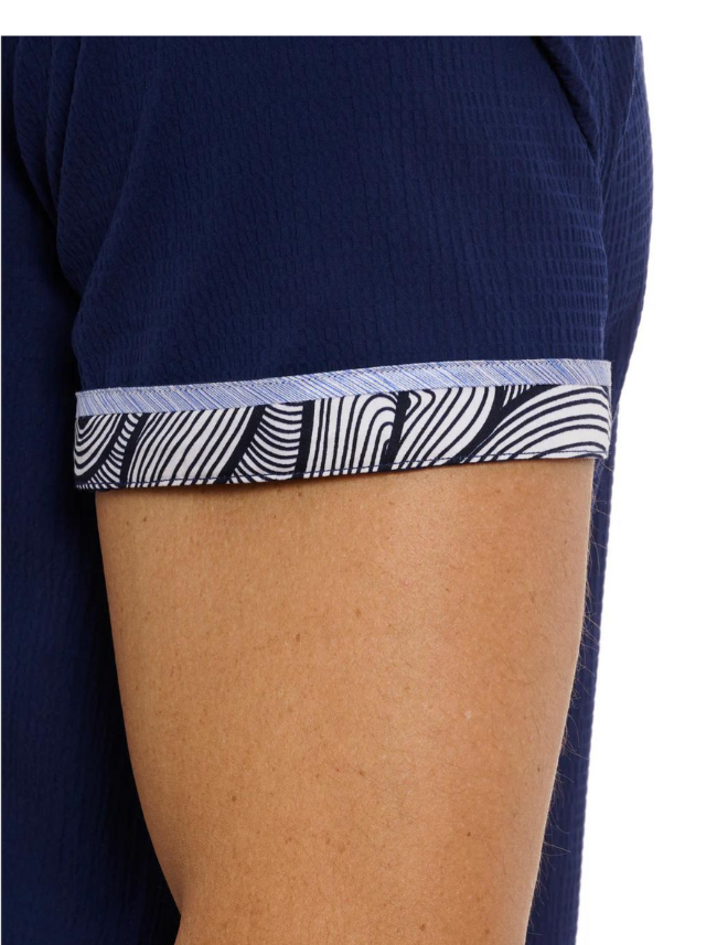 Close-up of a navy blue garment with a patterned waistband on a white background