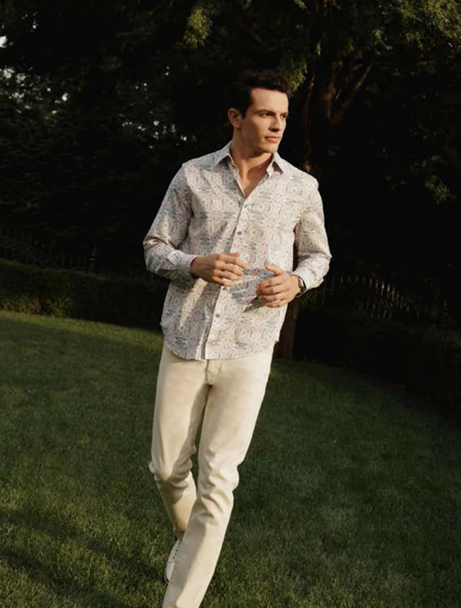 Model wearing Robert Graham Gomera Long Sleeve Shirt – bold floral print button-down styled for upscale casual or resort wear