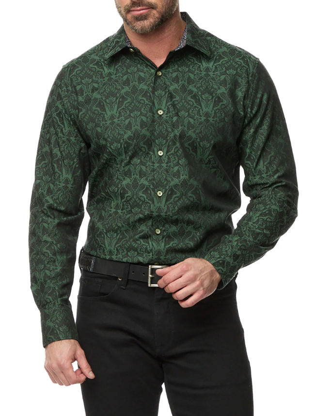 Man wearing a green patterned shirt and black pants on a white background