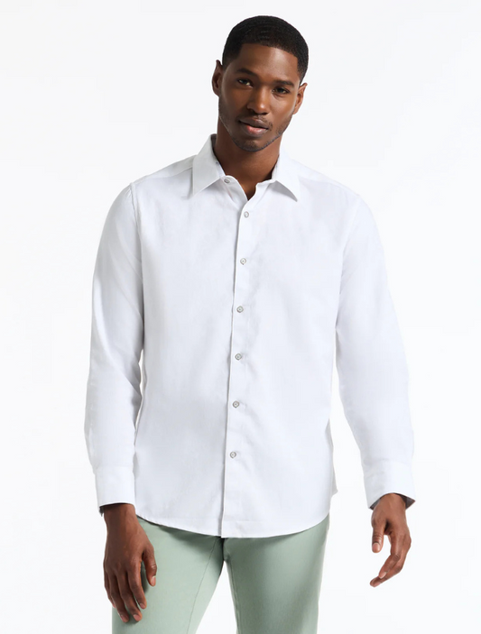 A man wearing a white long sleeve button-down shirt with a point collar.