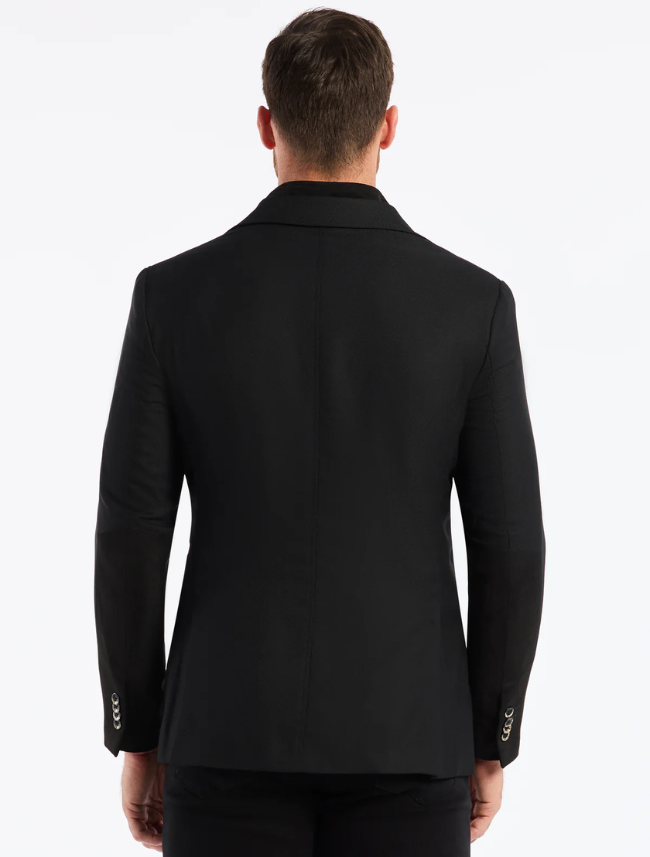 Man wearing a black suit jacket on a white background