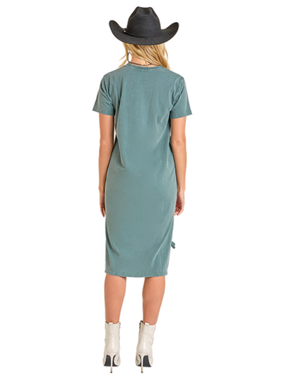Woman wearing a teal dress and black cowboy hat on a white background
