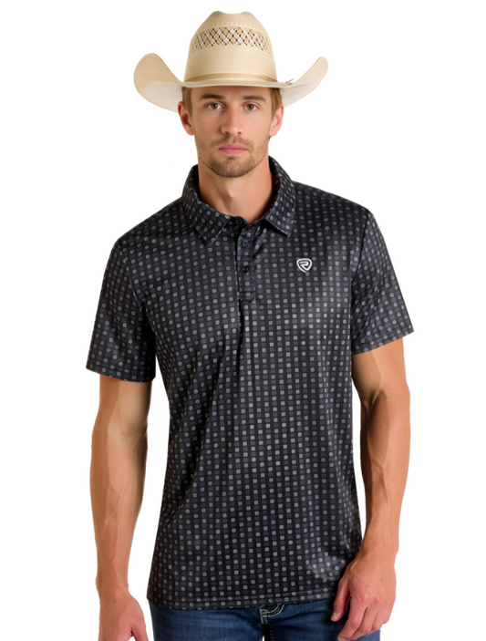 Man wearing a grey polo with geometric print on a white background.