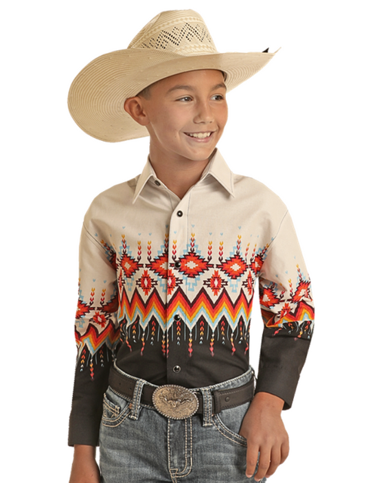 Boy wearing a beige shirt with a multicolored Aztec print against a white background.
