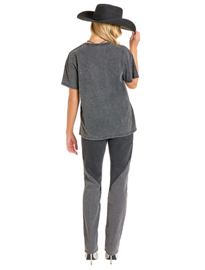 Woman wearing a gray oversized t-shirt with a wide-brimmed hat on a white background