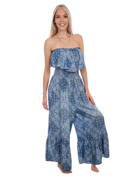 Woman wearing a blue patterned strapless jumpsuit on a white background
