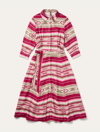 A Stetson women's mid-length dress with a western-inspired red and beige serape pattern, featuring a fold down collar, full length hidden button placket closure, 3/4 length sleeves with gather and button cuffs, and a fitted waistline with gather and tie.