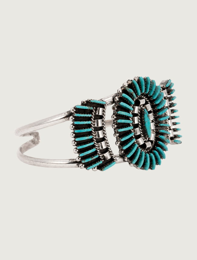 Quarter view of Edmund Cooeyate sterling silver Kingman turquoise needlepoint cluster cuff
